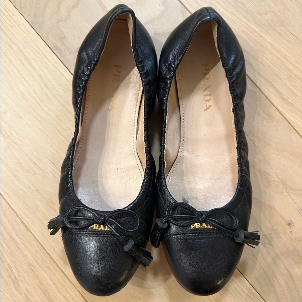 Prada Women's Black Leather Flats with Gold Accents